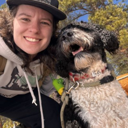Emma taking a selfie with a dog