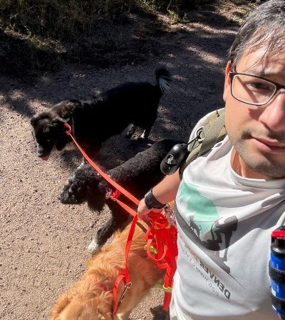 Enrique taking a selfie with a pack of dogs