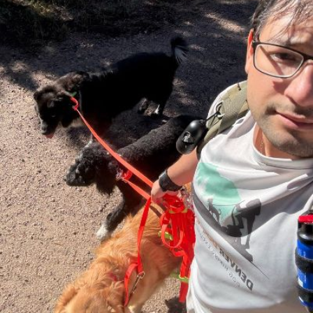 Enrique taking a selfie with a pack of dogs