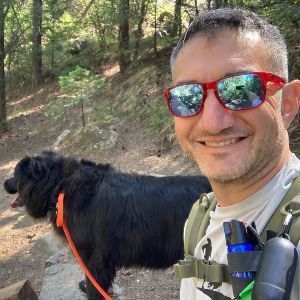 John taking a selfie with a dog on a hike