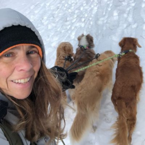 Kristen taking a selfie with a group of dogs