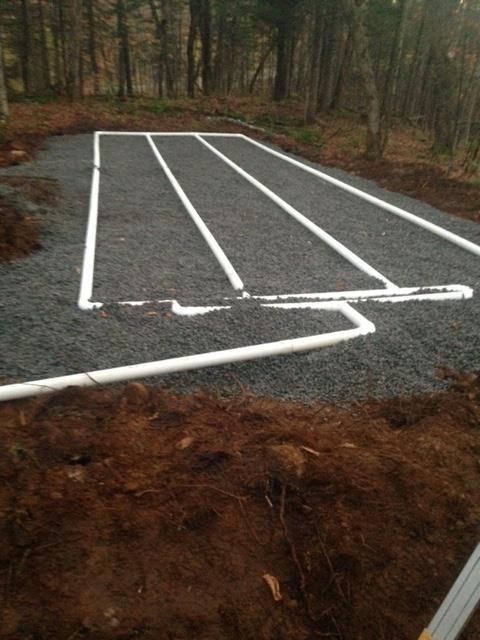 A white line on a gravel road with trees in the background