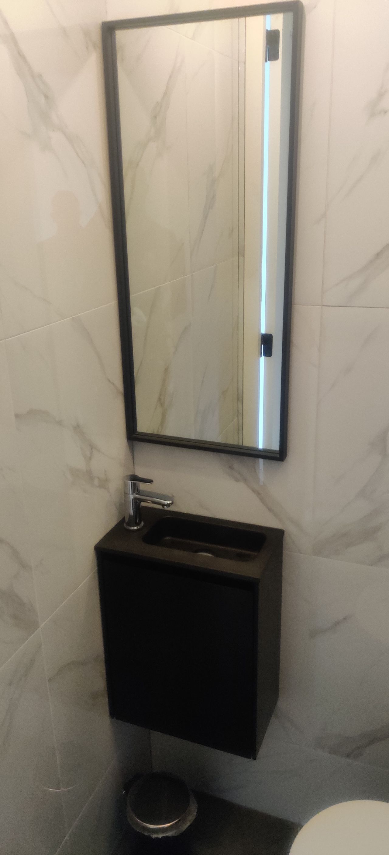 A bathroom with a sink , mirror and toilet