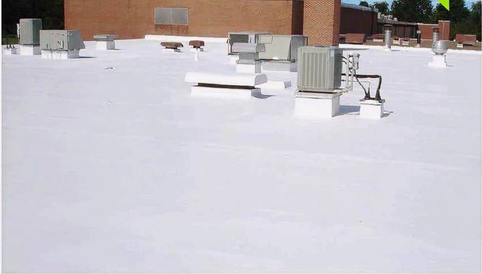 A white roof with a lot of air conditioners on it
