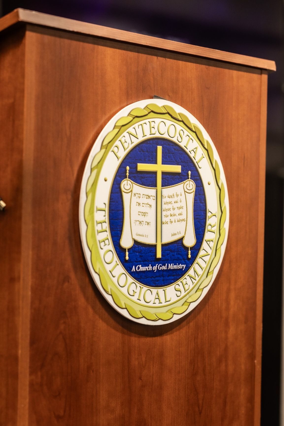 A podium with a pentecostal theological seminary logo on it