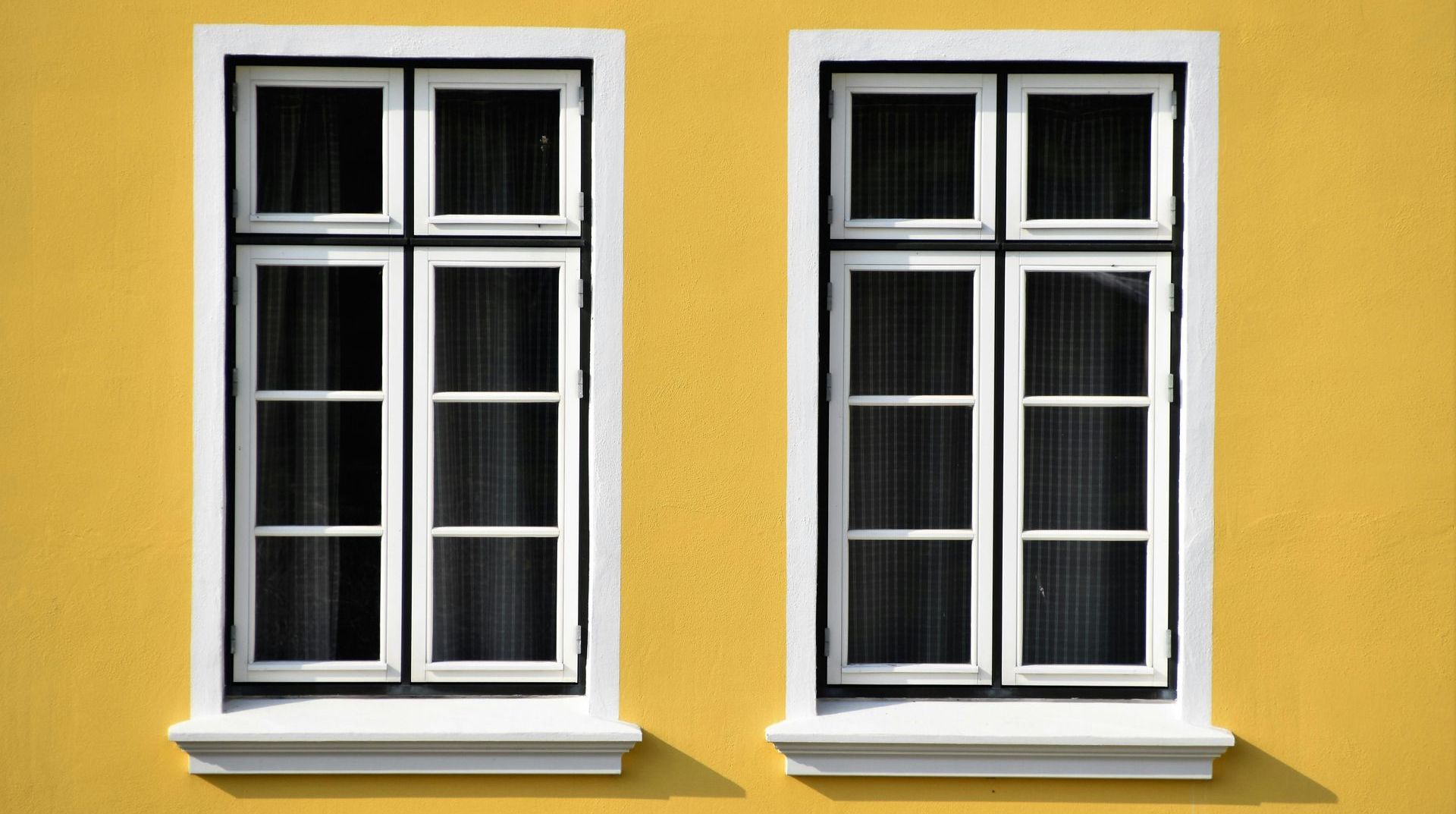 windows on a yellow house