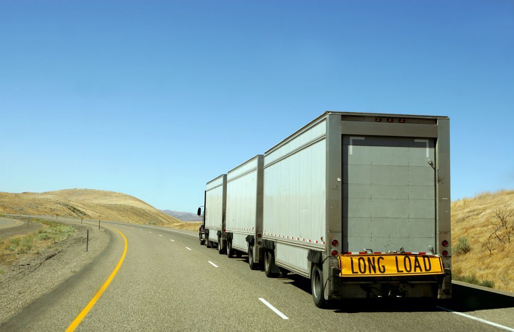 A Semi-truck With Two Connected Trailers Traveling — Downs Towing & Recovery Service in Moonie, QLD
