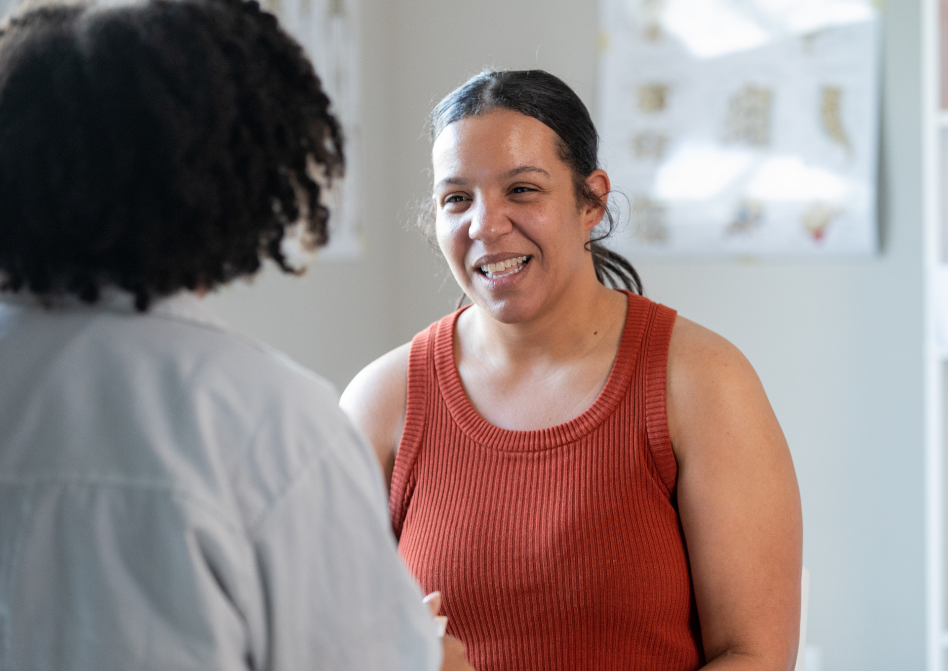 An elderly woman is being examined by a doctor with a stethoscope.