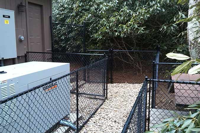 Black Chain Link Surrounding a Power Room—Peak Fence System in Franklin, NC