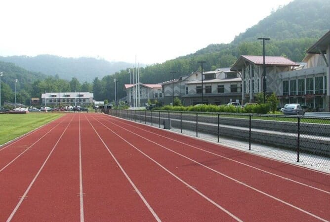 Black Chain Link on the Side of a Track and Field—Peak Fence System in Franklin, NC