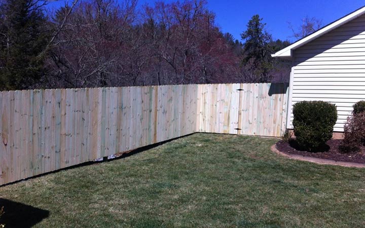 White Wood Fence Surrounding a House—Peak Fence System in Franklin, NC