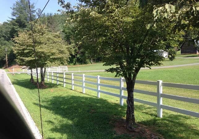 PVC Fence Beside some Trees—Peak Fence System in Franklin, NC