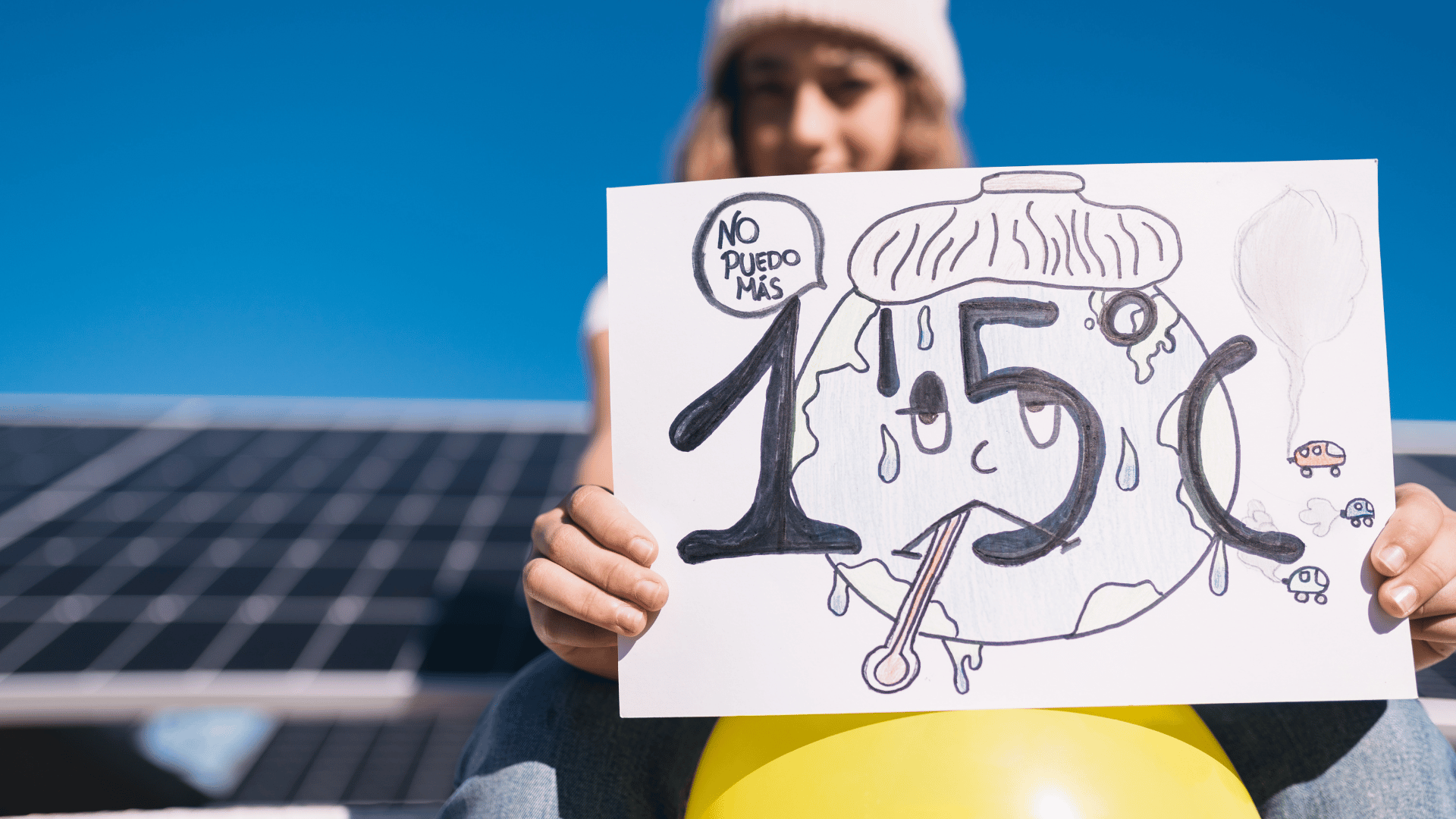 a woman is holding a sign in front of a solar panel .