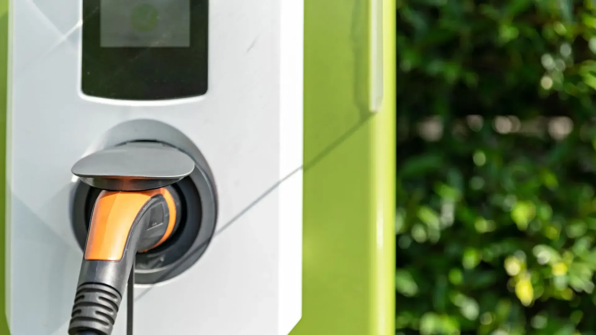 An electric car is being charged at a charging station.