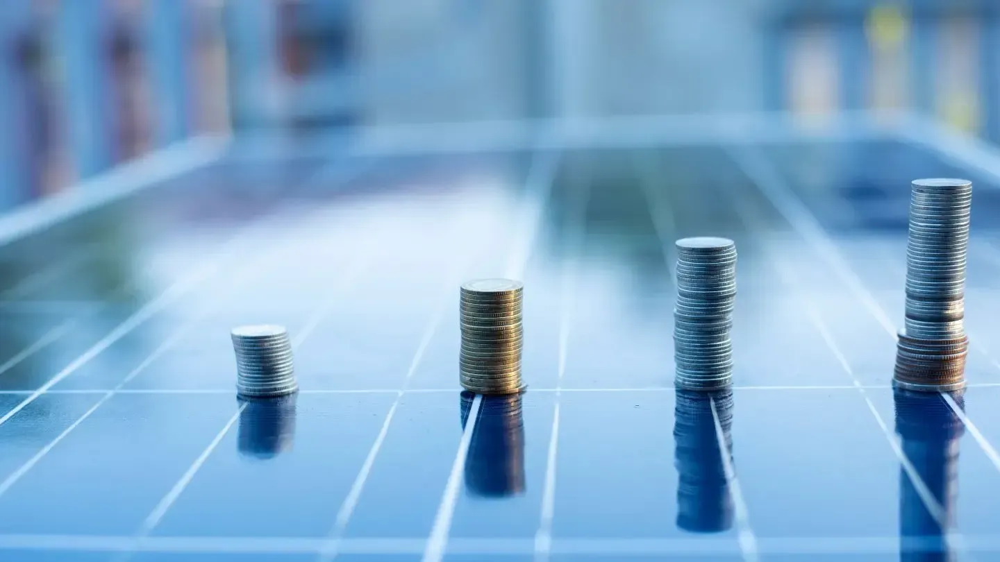 A row of coins stacked on top of each other on a solar panel.