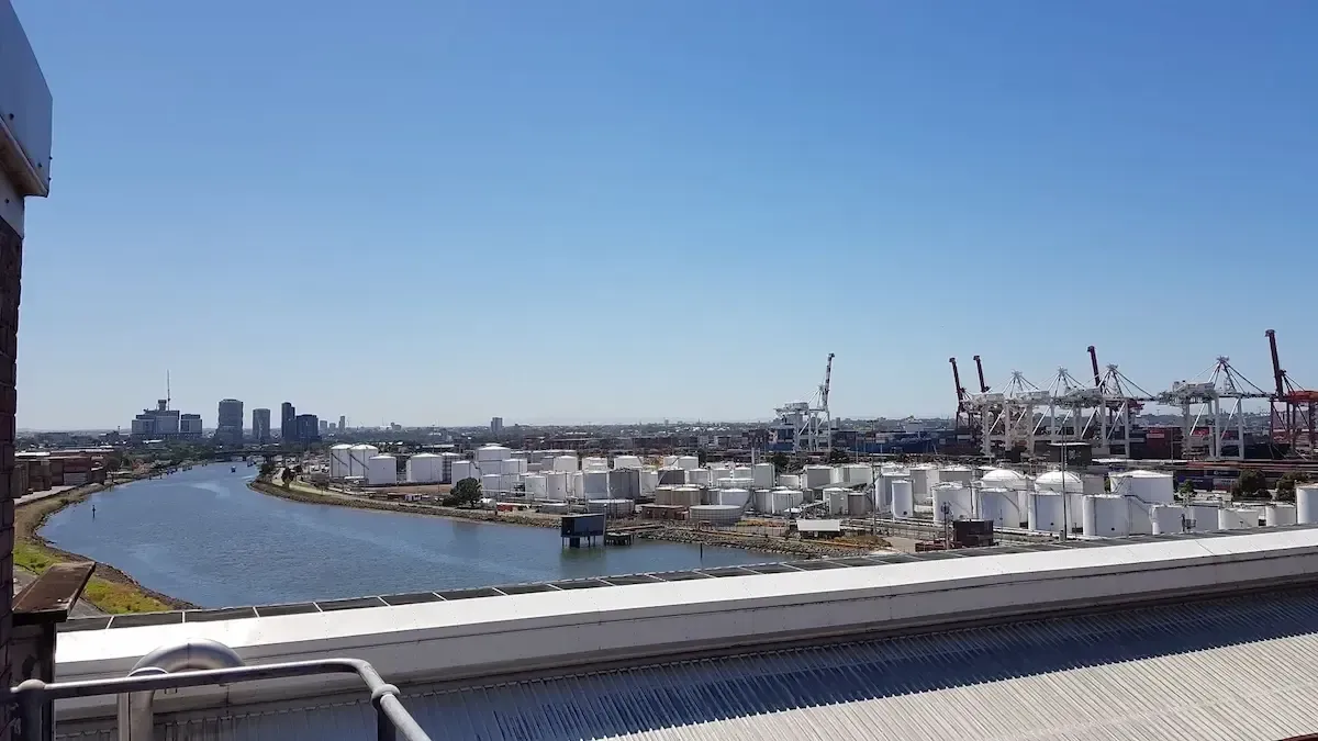 A view of a city from a rooftop with a river in the foreground.
