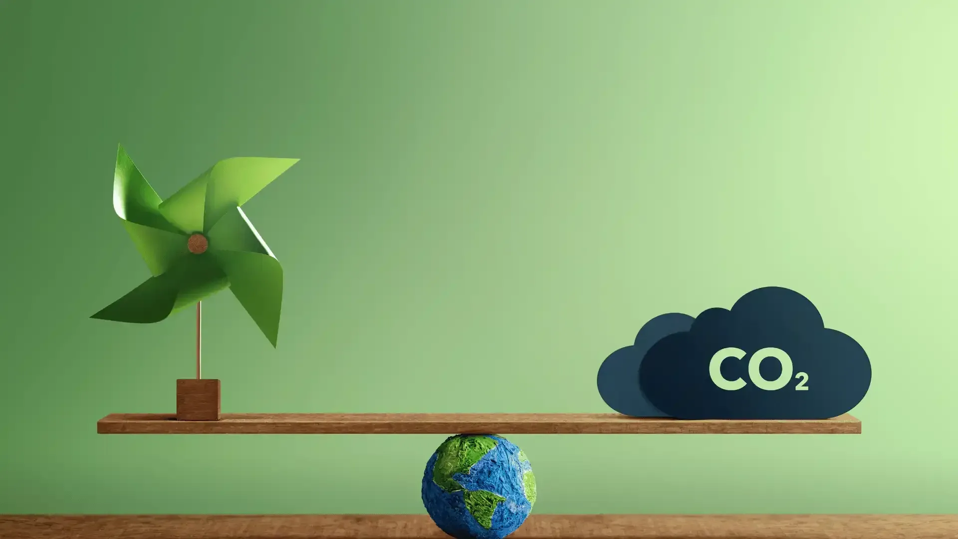 a windmill and a cloud of co2 are on a wooden scale .