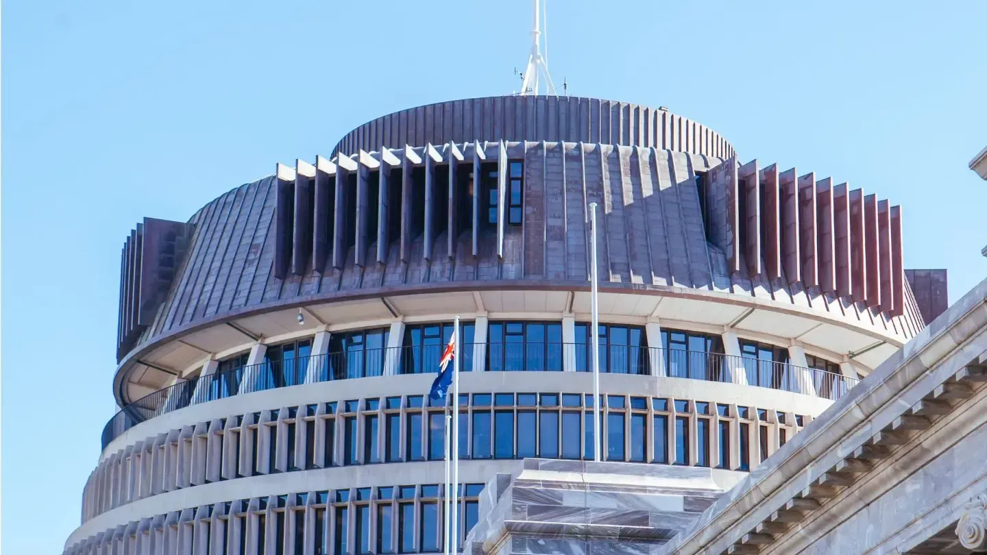 Beehive building, Wellington, New Zealand, with the national flag flying on a sunny day.