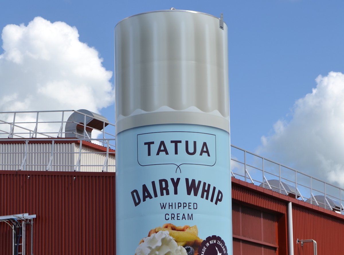 a can of tatua dairy whipped cream in front of a building