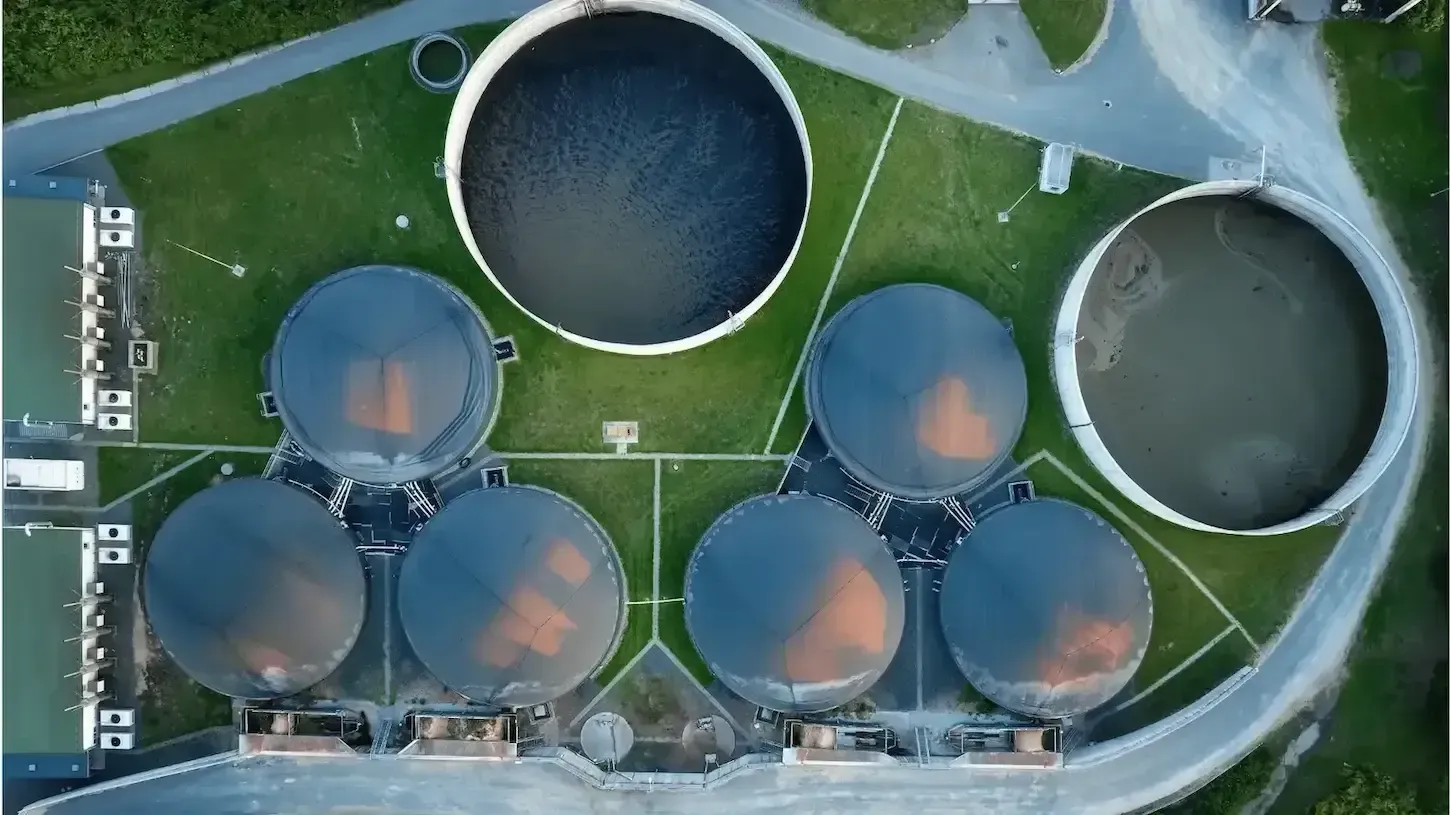 An aerial view of a water treatment plant with a lot of tanks.