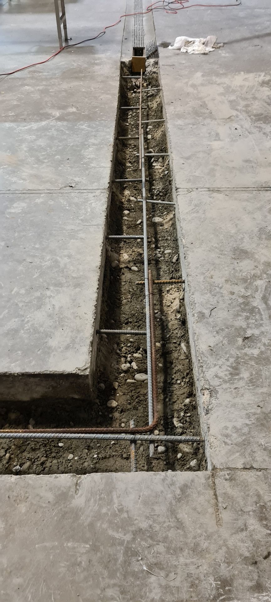 A concrete wall is being built on a concrete floor.