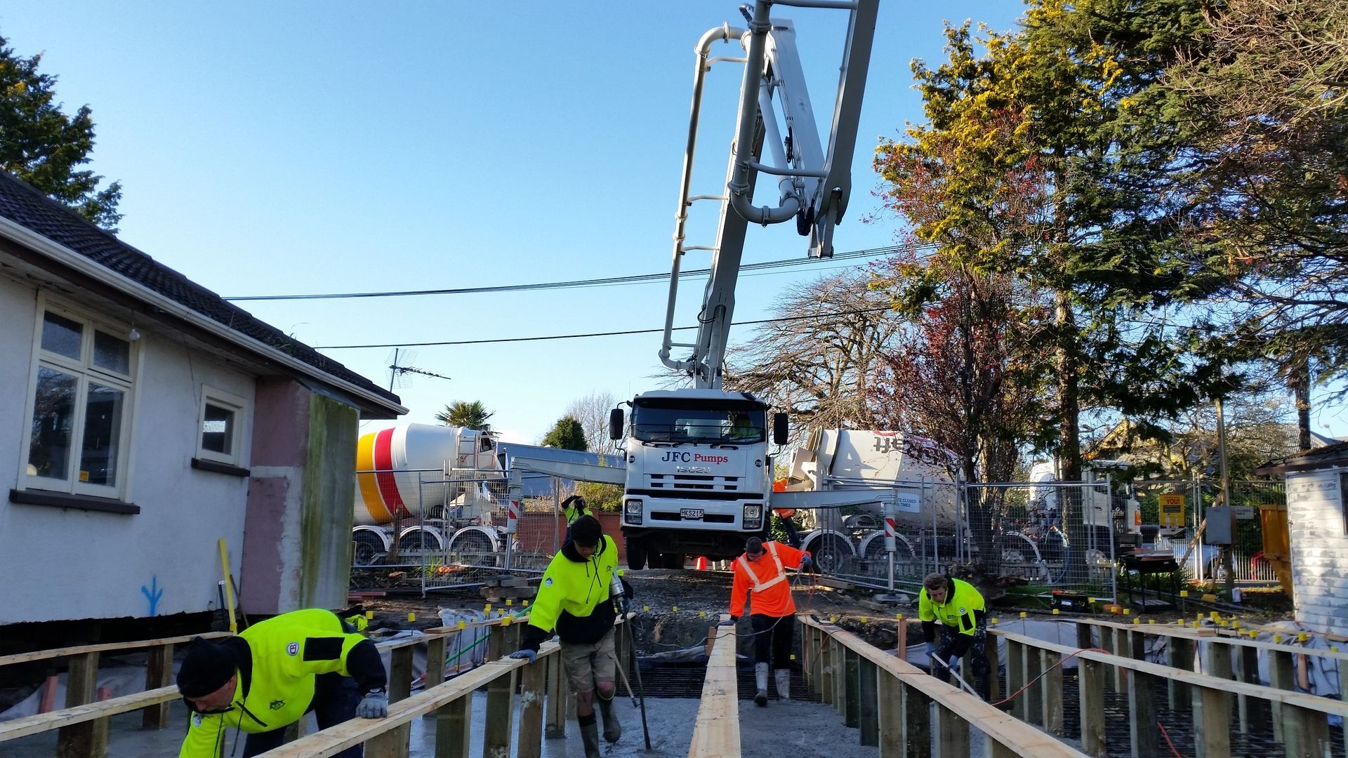 A group of construction workers are working on a bridge.