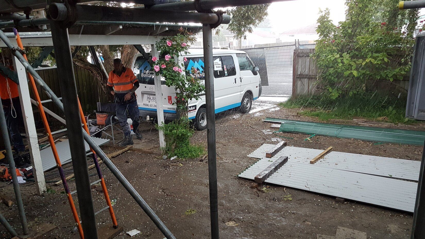 A white van is parked in the backyard of a house.