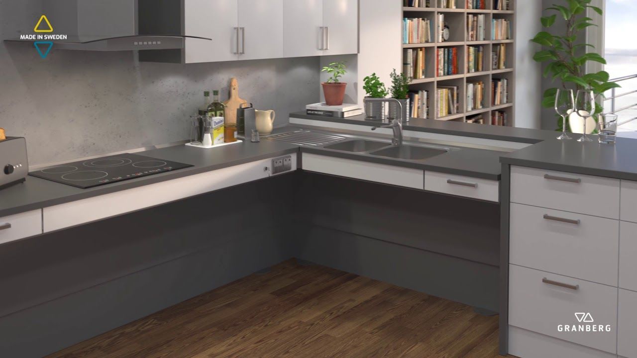 A kitchen with a sink , stove , and bookshelf.