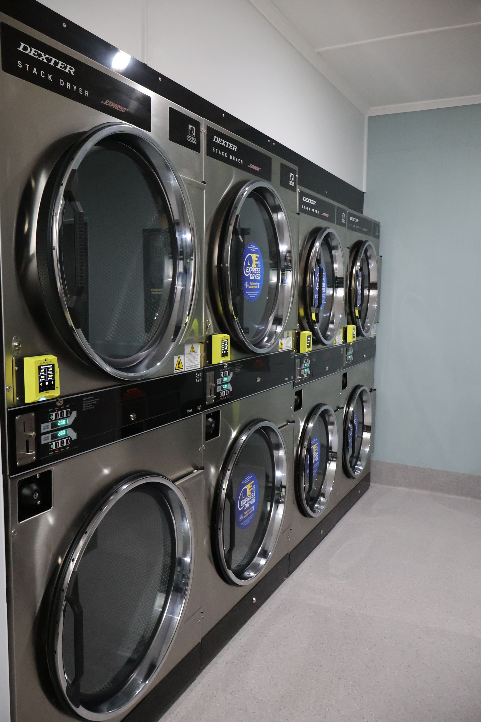 Eight washing machines stacked on top of each other in two rows of four— WashFold Laundromat In  Allenstown, QLD