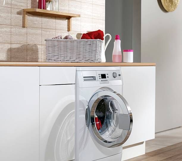 Washing machine with open door in a laundry room.