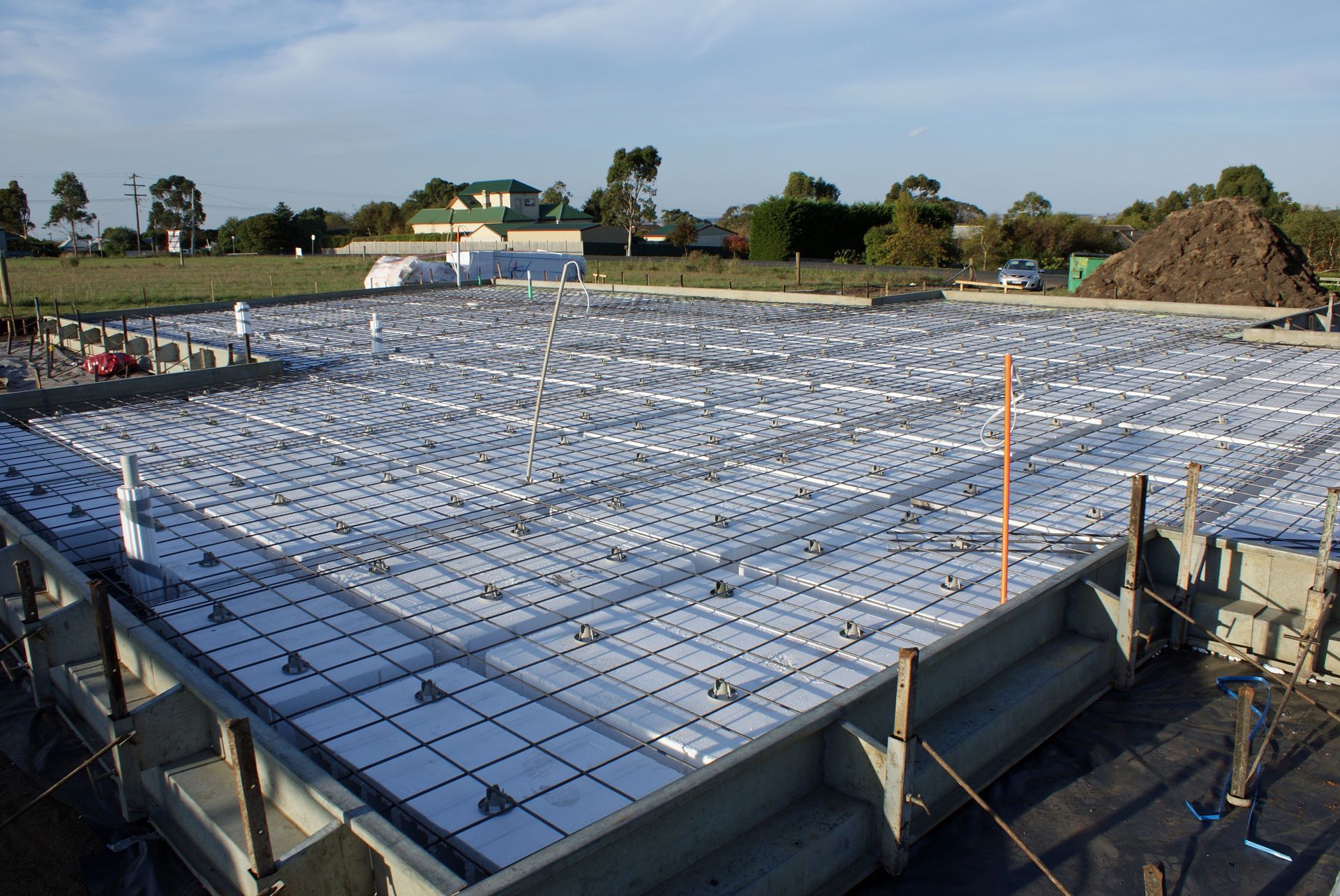 Rebar grid and formwork for a concrete foundation at a construction site