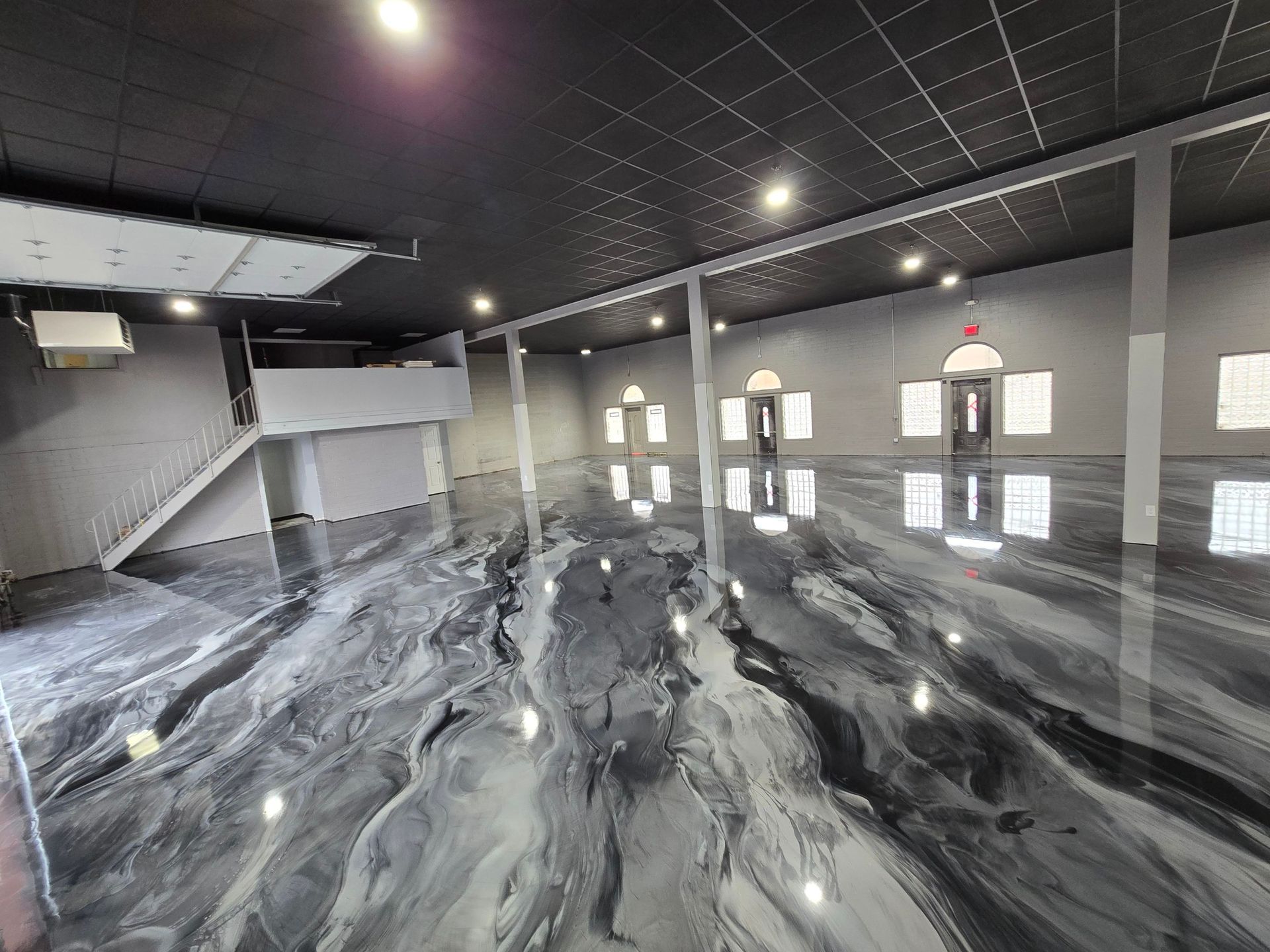 A large room with a marble floor and a black ceiling.