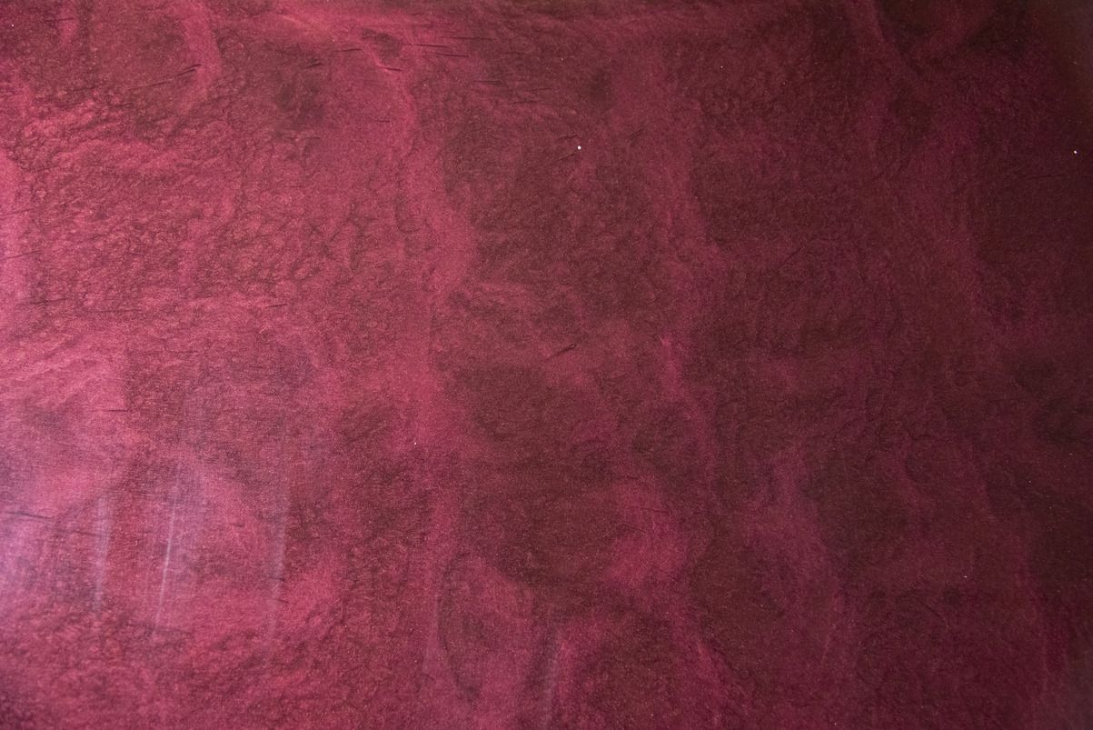 A close up of a red leather texture.