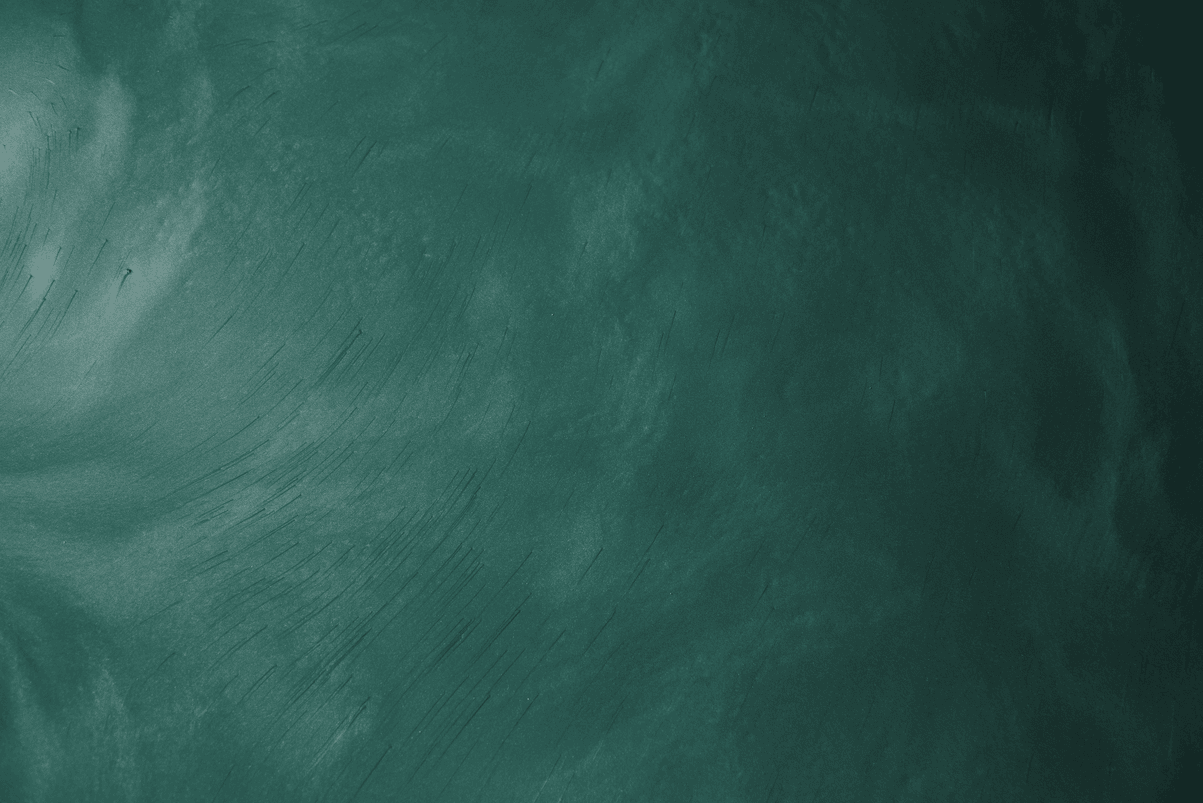 A close up of a green chalkboard with white chalk on it.