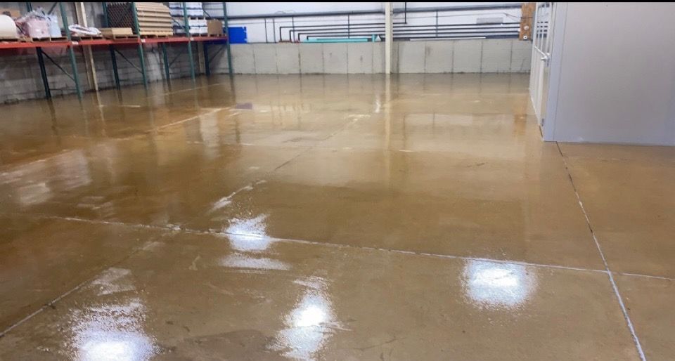 A large warehouse with a shiny concrete floor.