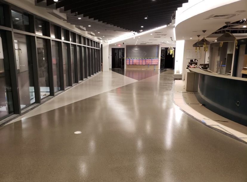 A long hallway with a lot of windows and a counter.