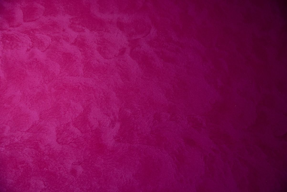A close up of a purple background with a texture.