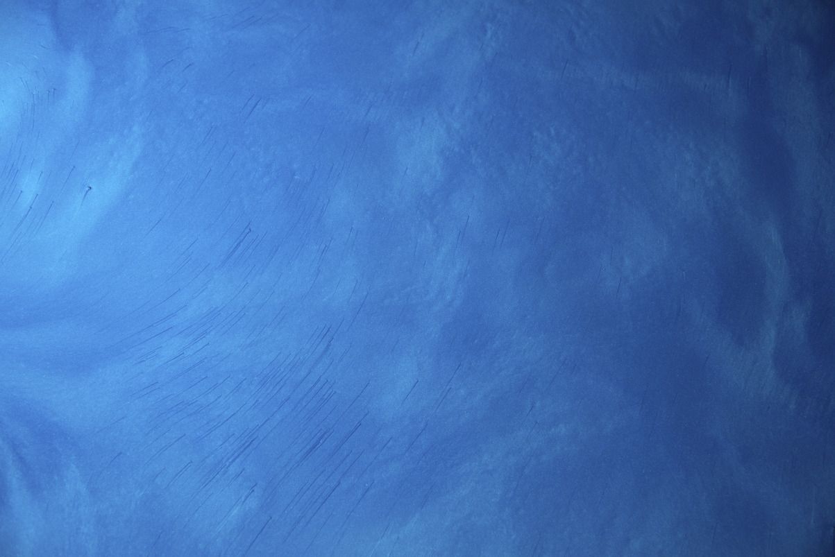 A blue background with white clouds in the sky