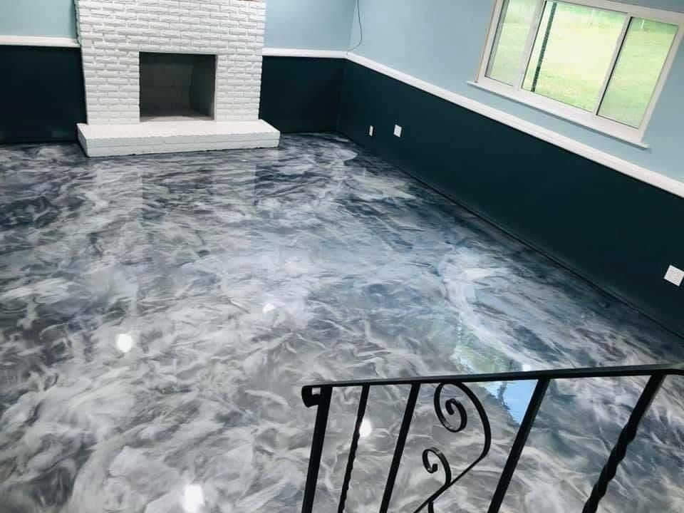 A living room with a fireplace and a metallic floor.