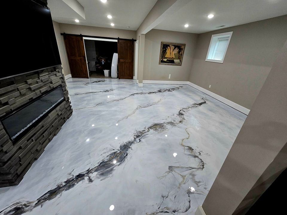 A basement with a marble floor and a fireplace.