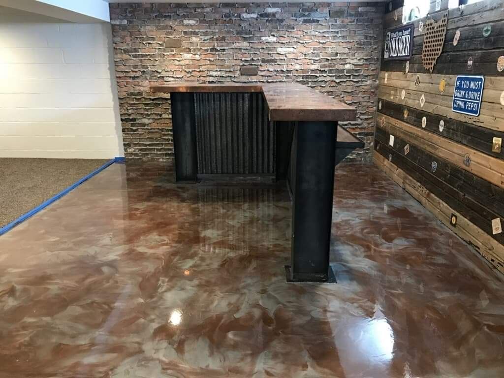 A basement with a bar and a brick wall.