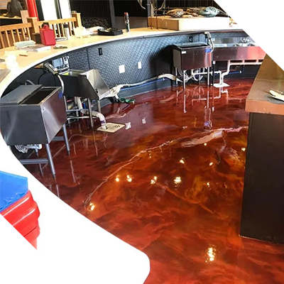 A restaurant with a red metallic floor and sinks.