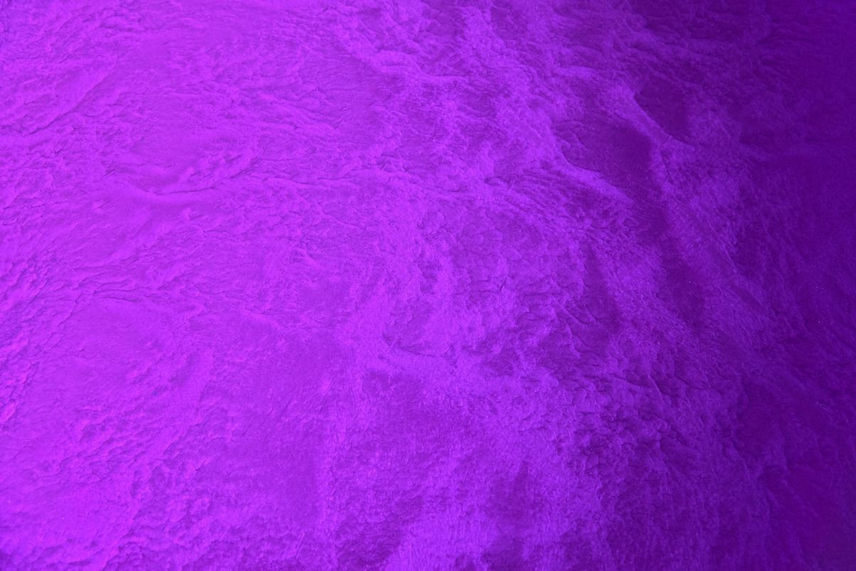 A close up of a purple paper texture.
