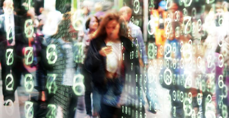 a blurred image of people walking behind a wall of numbers
