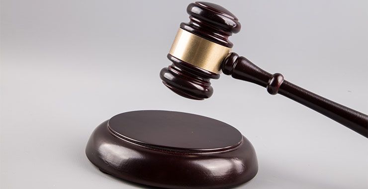 a wooden judge 's gavel is sitting on top of a wooden base .