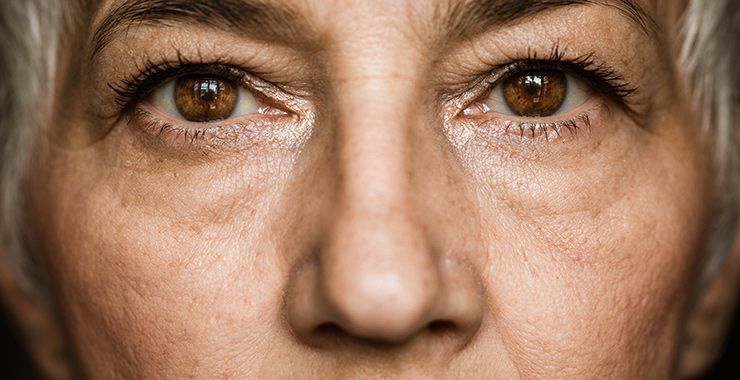 a close up of an older woman 's eyes and nose