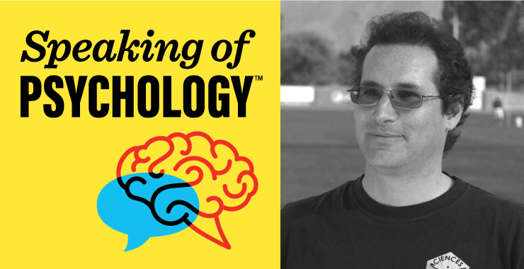 a man stands in front of a yellow sign that says speaking of psychology