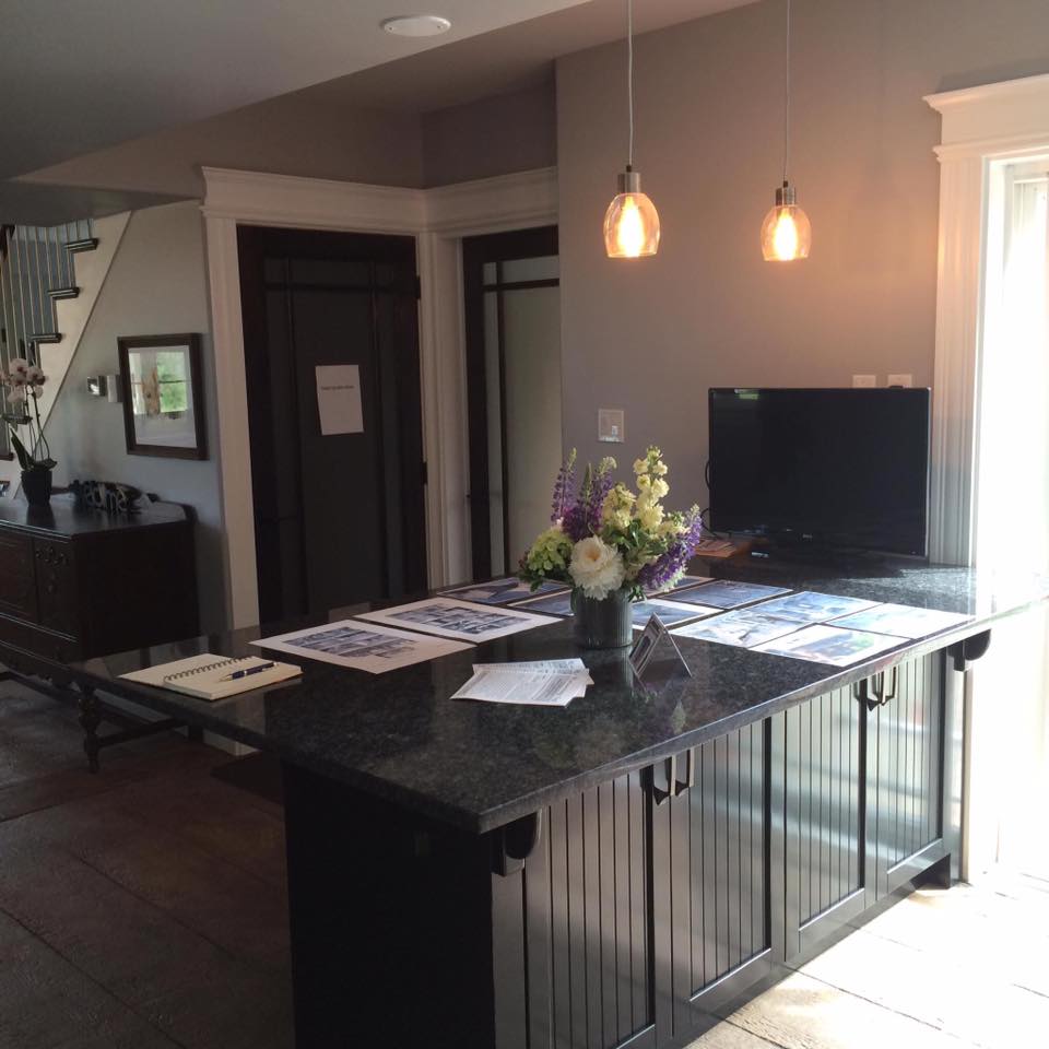 A kitchen island with a vase of flowers on it
