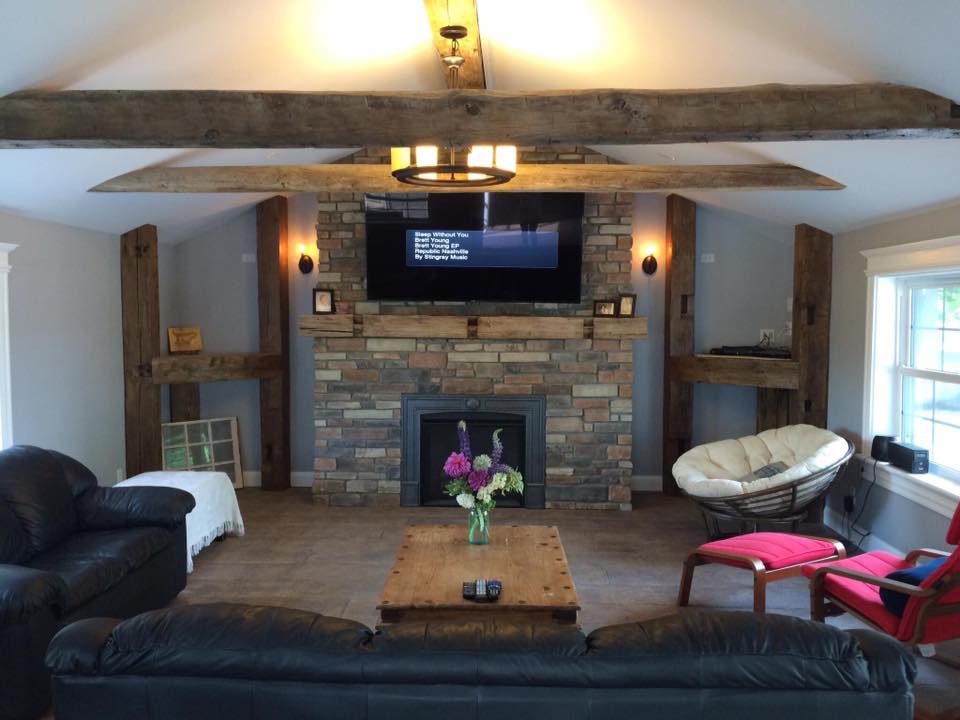 A living room with a fireplace and a flat screen tv