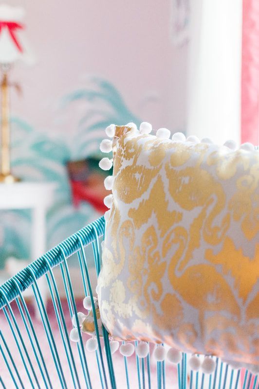 A yellow and white pillow is sitting on a blue chair